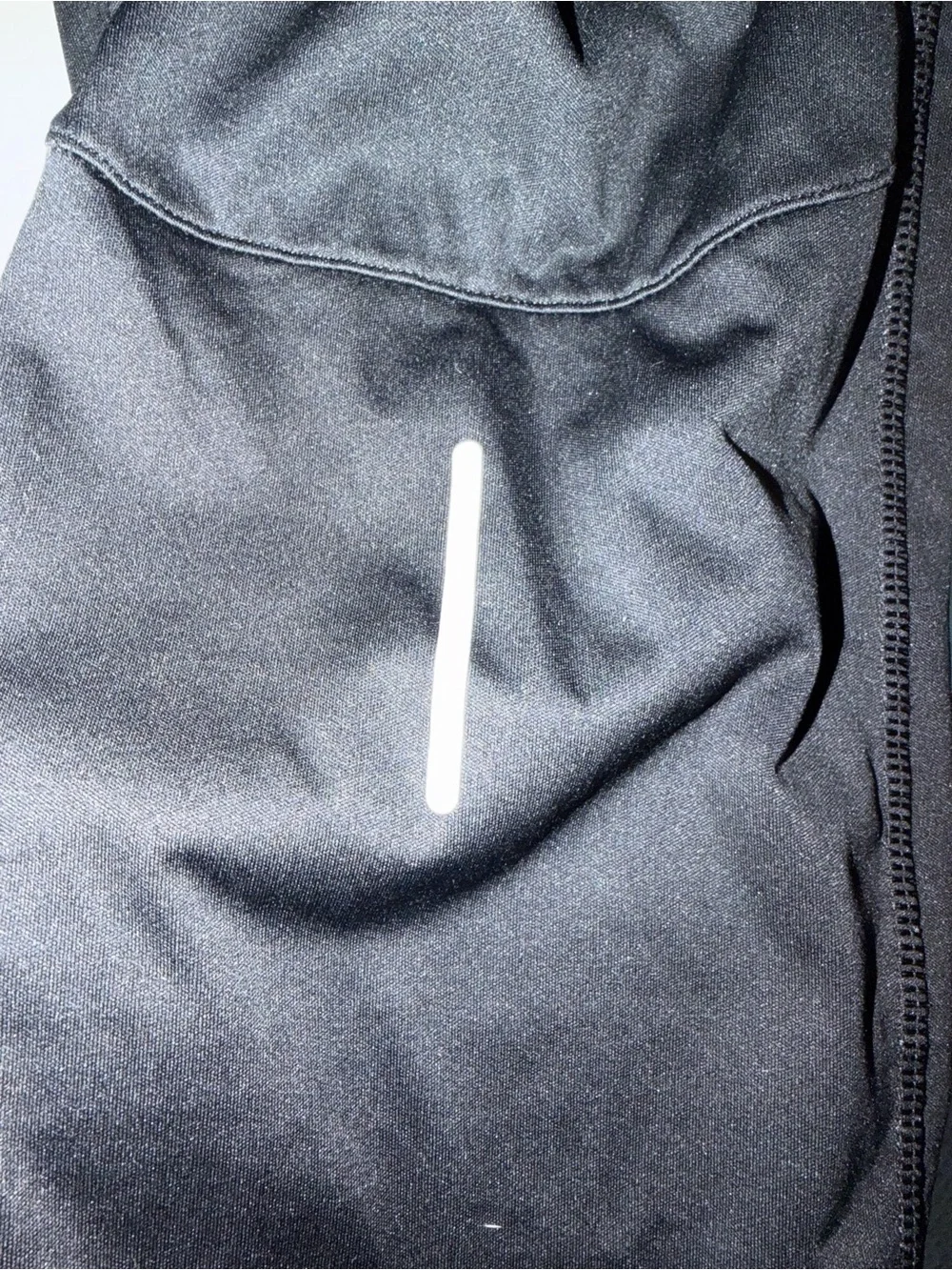 Nike Black Track Pants with White Swoosh and Reflective Details
